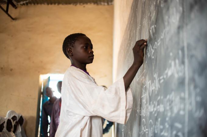 Mohamed writing on the black board during a class session at Golo Algadeeda Primary School.