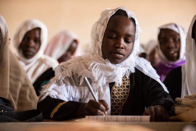 Shaymaa*, 11, a pupil from Golo Al Gadida Primary School taking notes during a class session.